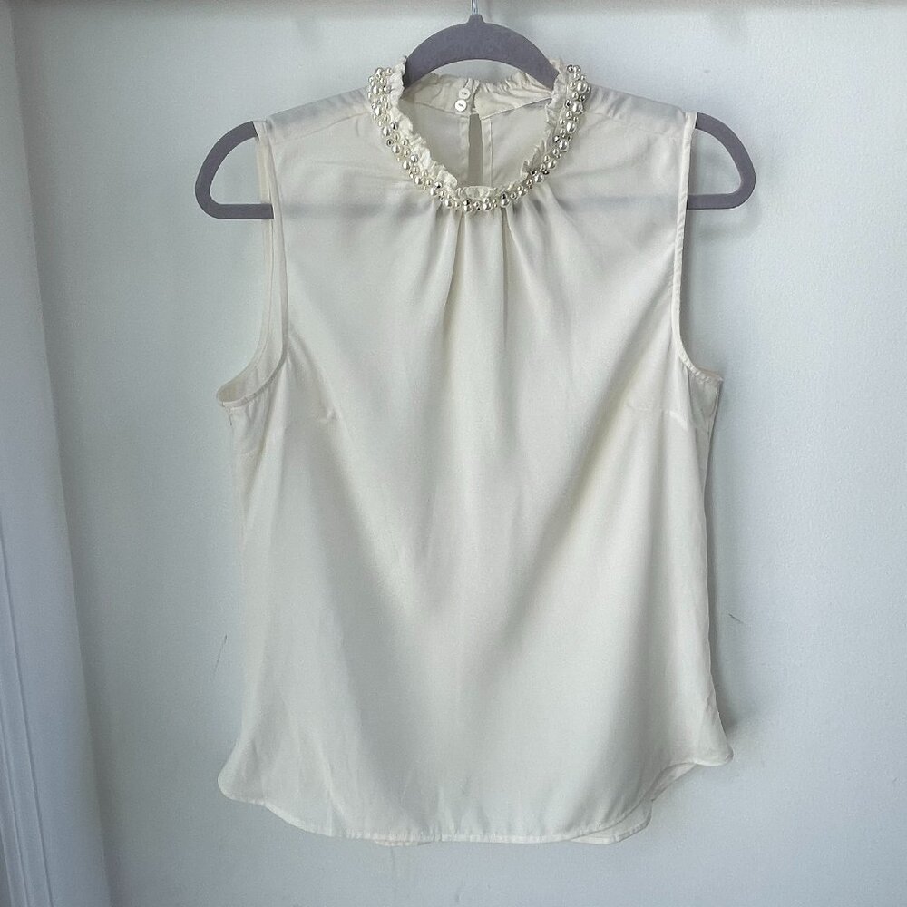 Offwhite sleeveless blouse with pearl detailing at neck size 10